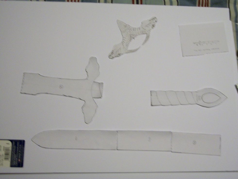 Take the scissors and cut the template for the weapon out.