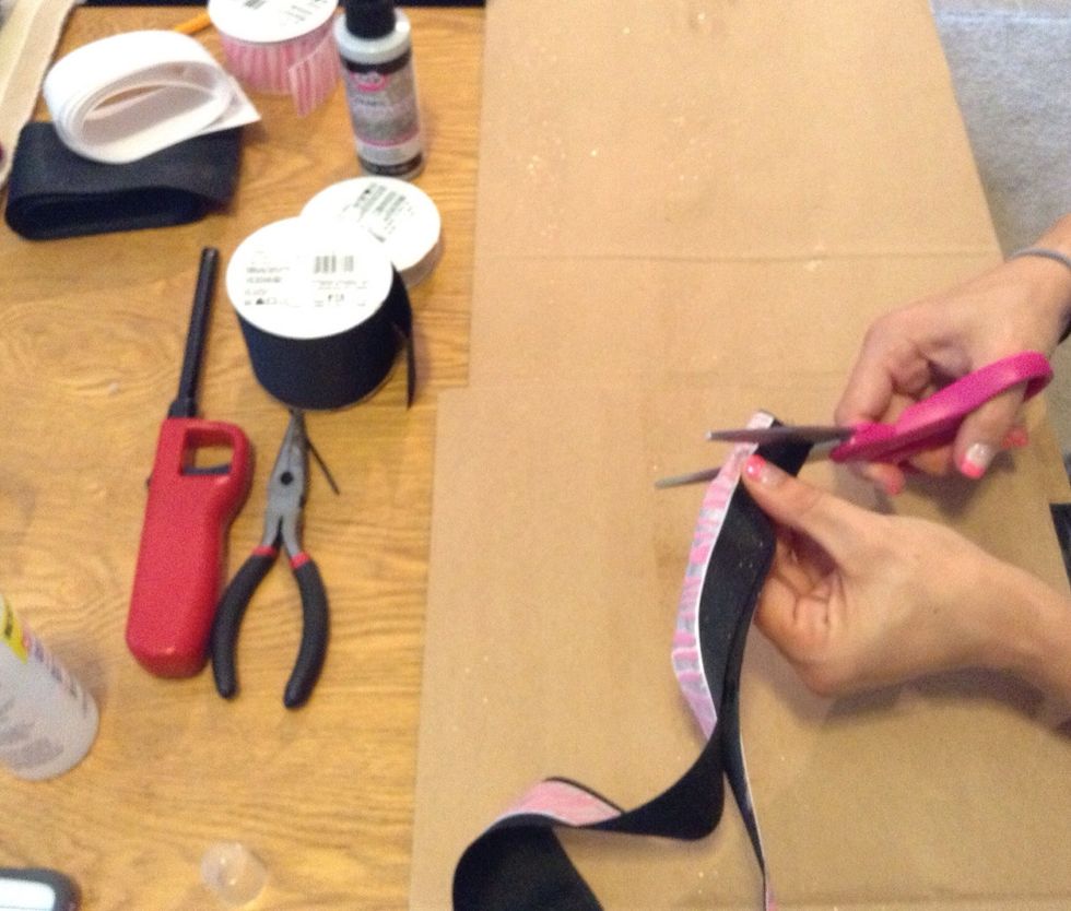 Take the scissors and start at the corner of the end of the ribbon and cut diagonal toward the middle.