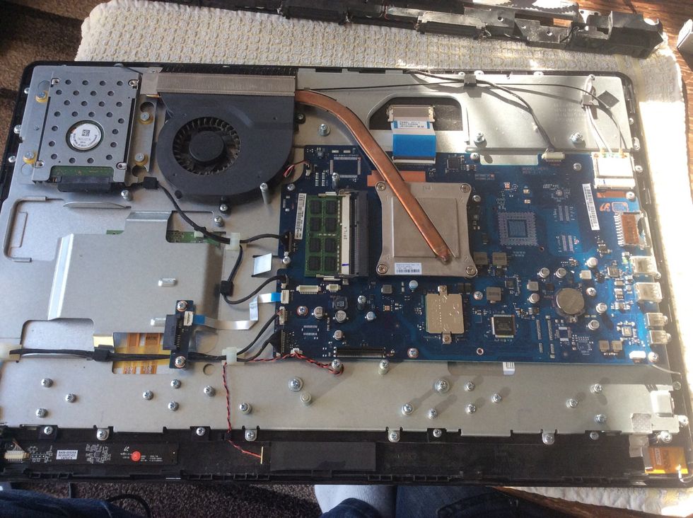 Take the screws out holding the next metal panel, the motherboard/hard drive and fan will come away with it so do not remove these. Take off any cables that stop the metal panel coming away in one.