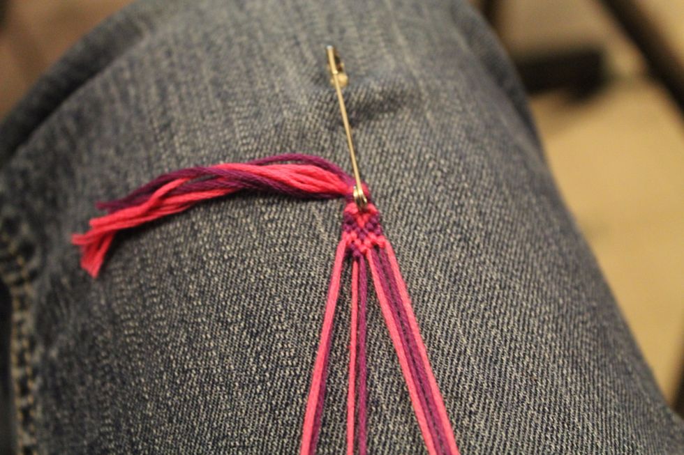 Take the second string in on the left and tie the foreword knot going right over the next two strings going right.