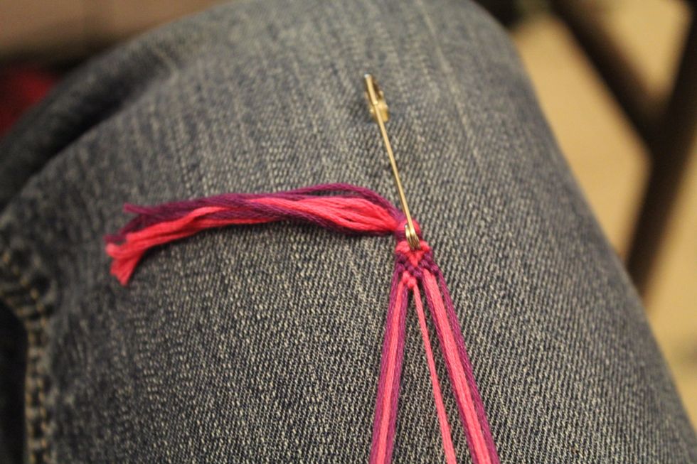 Take the second string in on the left and tie the foreword knot going right over the next two strings.