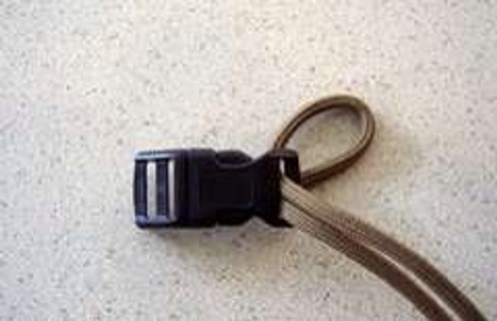 Take the shackle/buckle, and fold the rope in half. Feed the doubled rope through the gap.