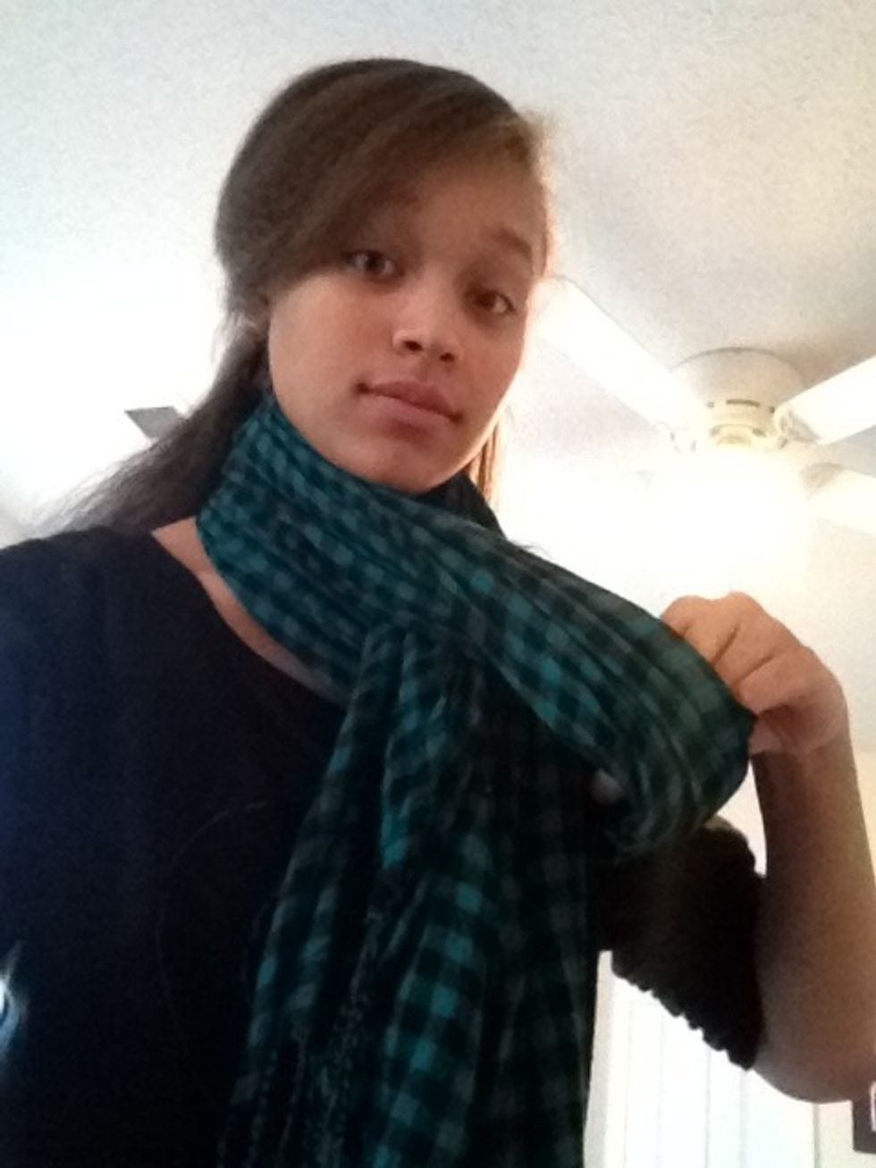 Take the side that isn't folded and pull it through the gap in the folded side