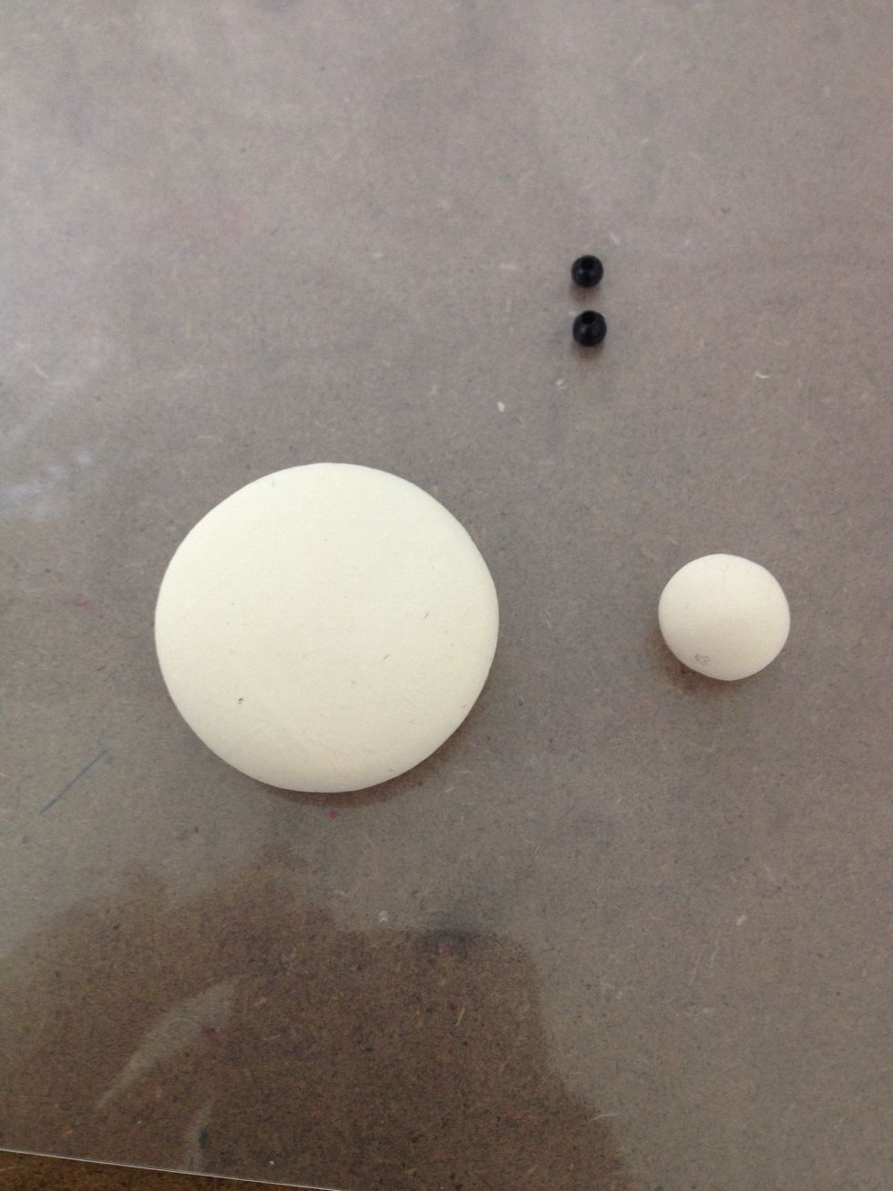 Take the skin color clay. Make a big and a small circle as the Santa face and nose.