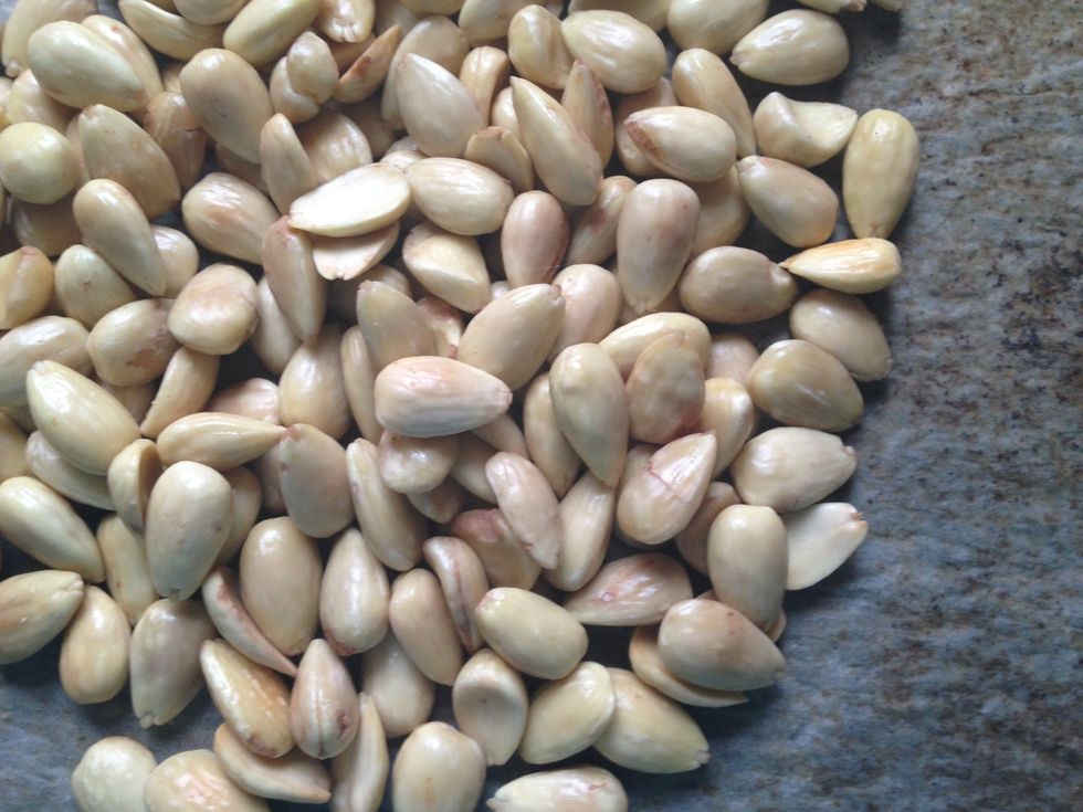 Take the skin of the almonds by boiling them for a minute or two, and thereby also removing the poison in the bitter almonds. They are added because they intensify the taste of almonds.