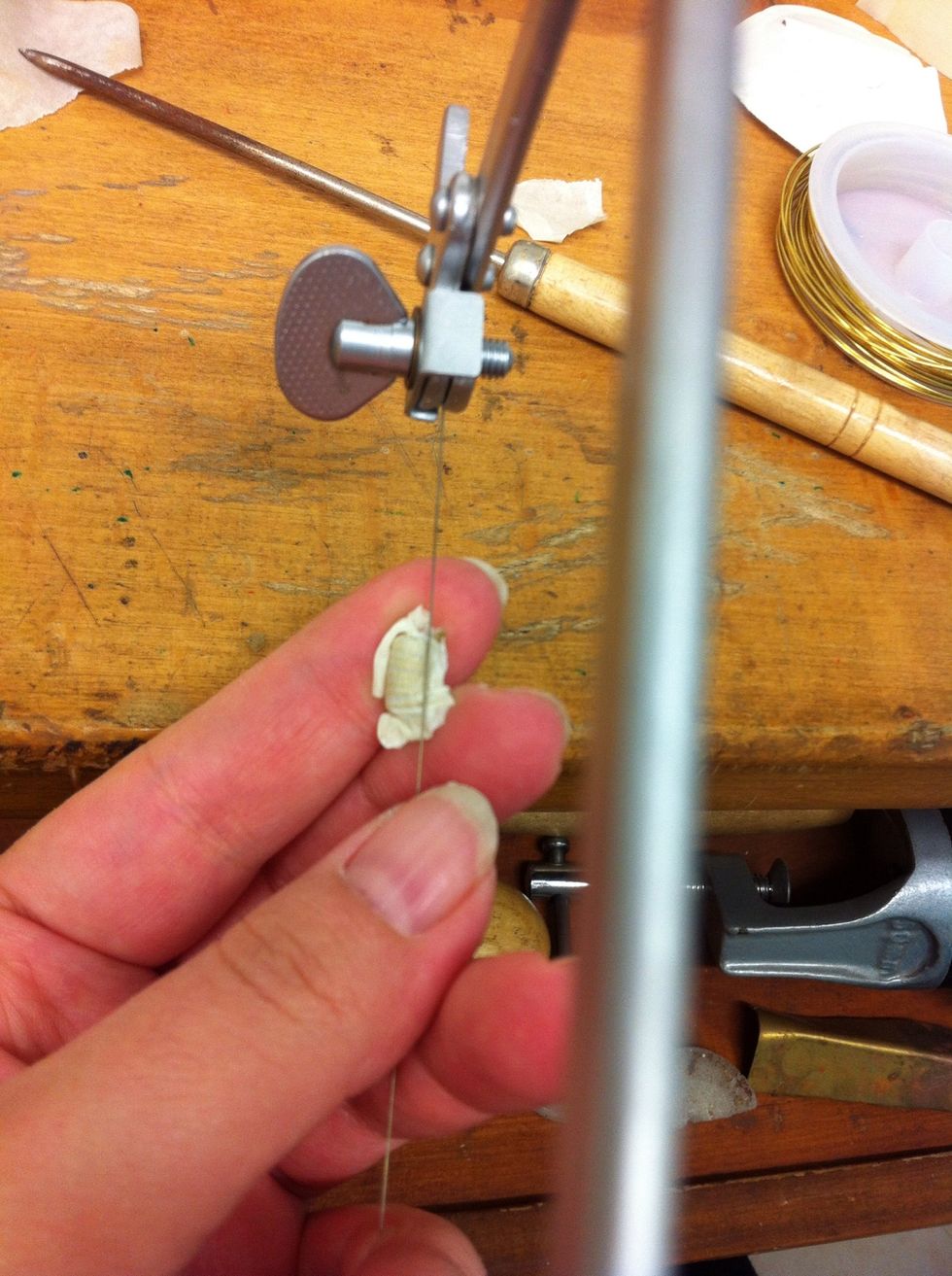 Take the small hacksaw and place it on the tube that we made and start moving your hands in opposite direction (when one hand is moving up- the second hand is moving down and vice versa).