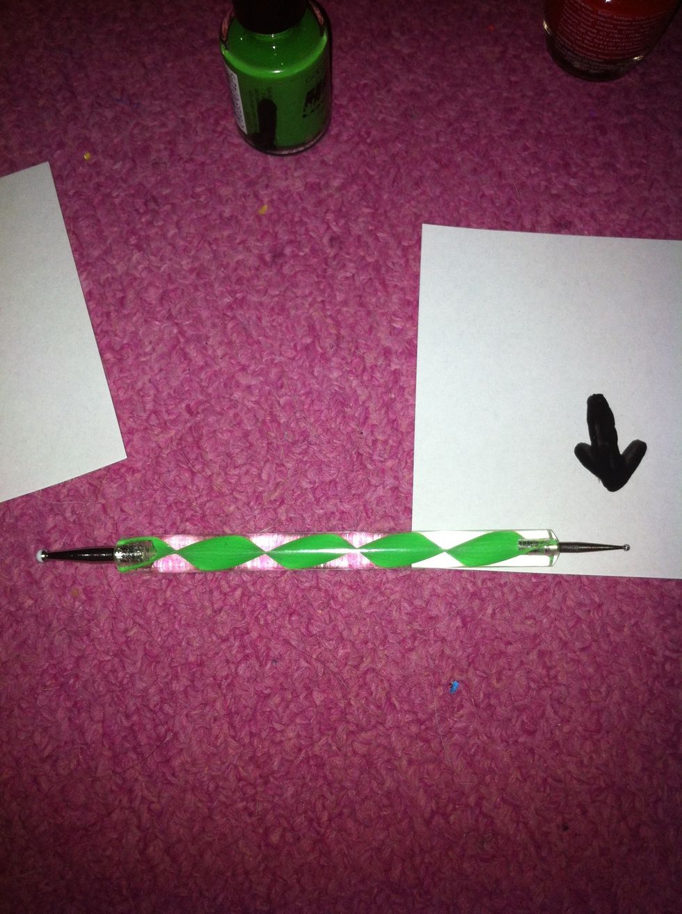 Take the smaller end of the dotting tool.