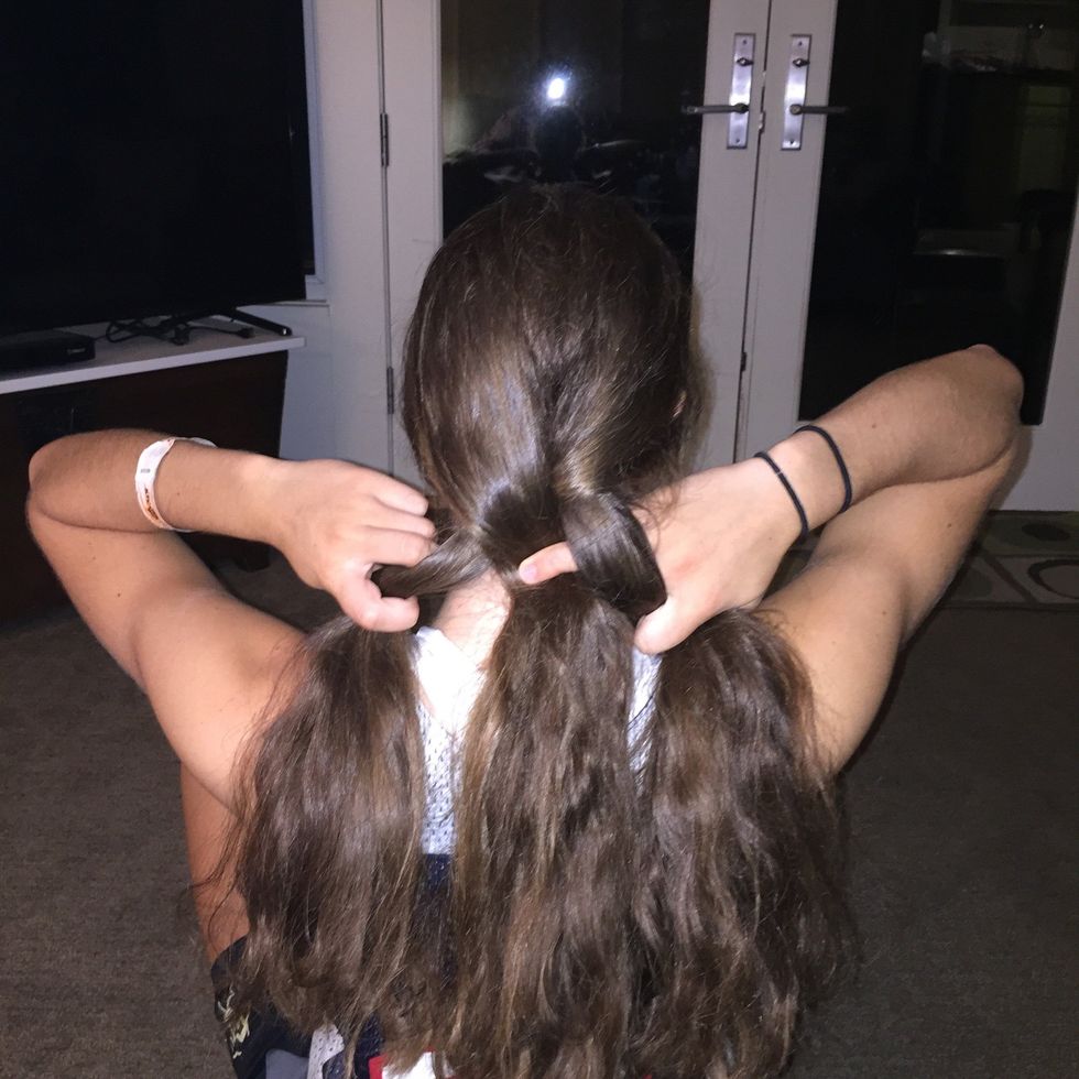 Take the strand on the left, and cross it over the top of the strand that is in the middle. The left strand should be in the middle now, and the strand that was in the middle should be on the left.