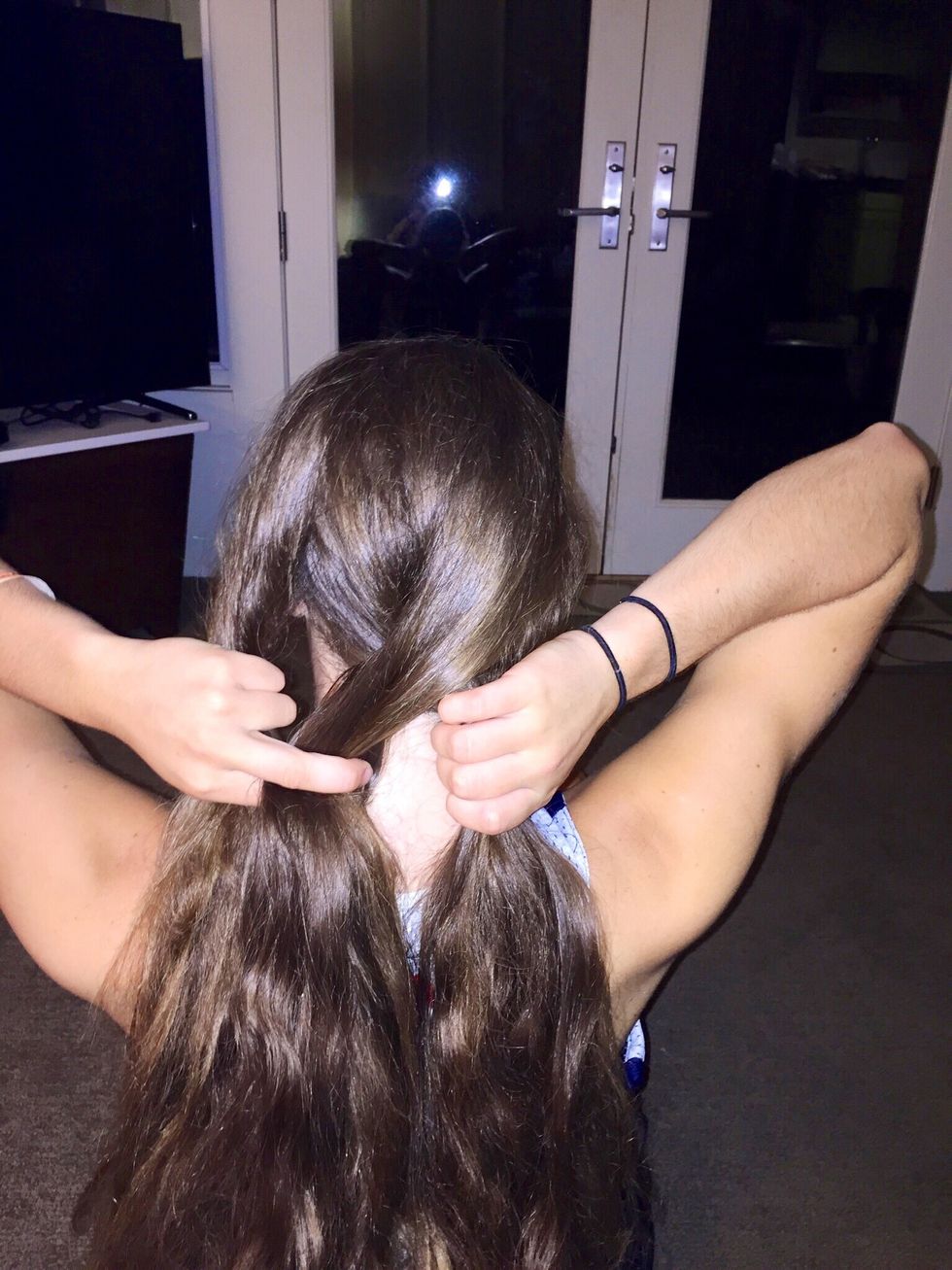 Take the strand on the right, and cross it over the top of the middle strand. The strand you crossed over should be in the middle now, and the middle strand should be on the right.