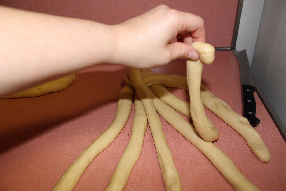 Take the strand that is 2nd from the right and cross it all the way to the left