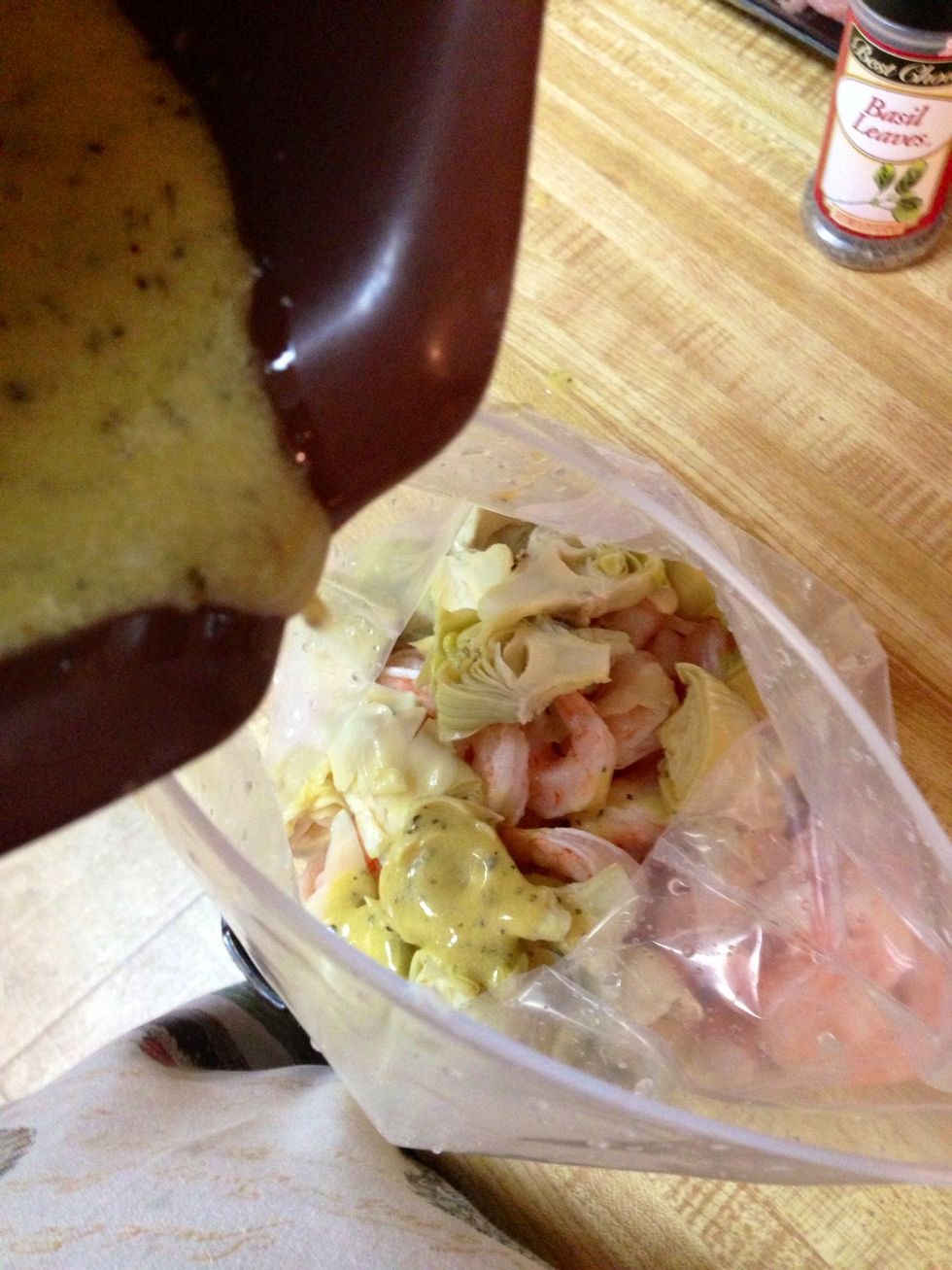 Take the tails off the shrimp, drain the artichokes and cut them in half. Pour the dressing over the shrimp mixture and toss well. Cover and refrigerate. Done.