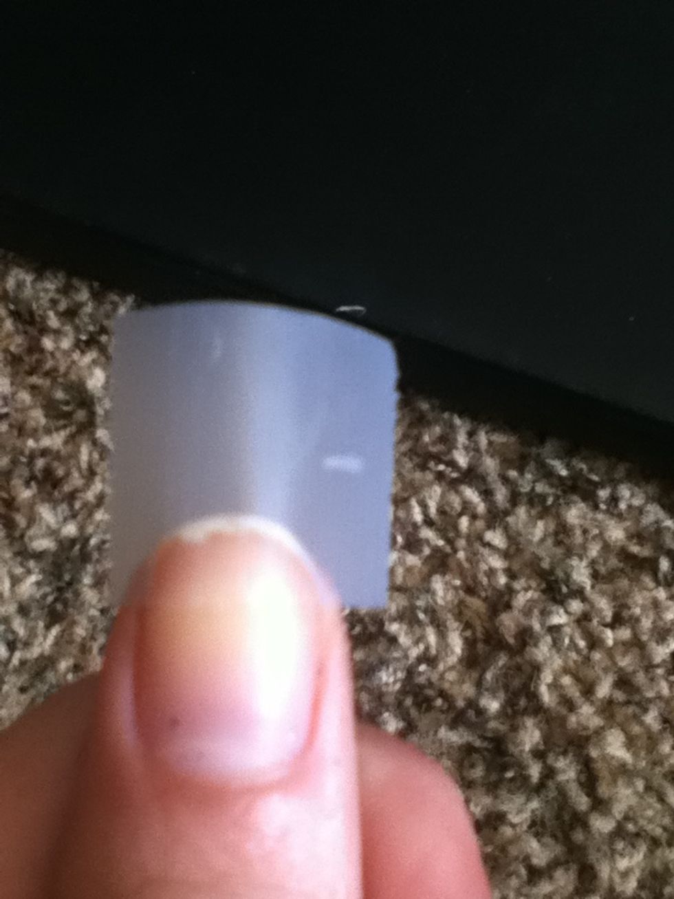 Take the tape and place it sideways on just the tip of your nail