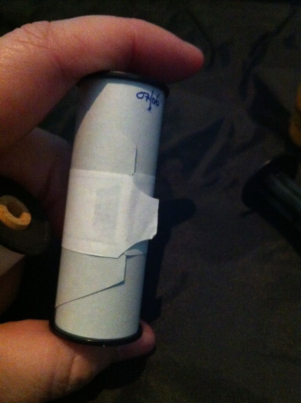 Take the tape off and start to unscroll the film. You can use the spare 120 spool for this.