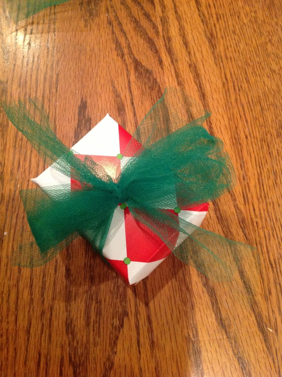 take the tied piece and make another knot over the folded piece of tulle