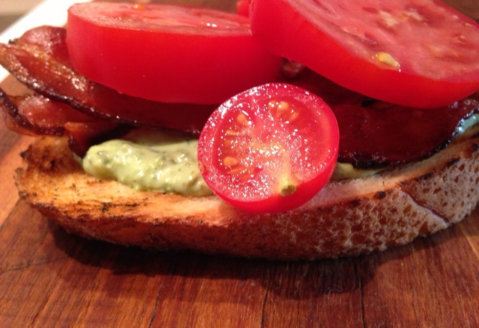 Take the toasted bread and slather it with the basil mayonnaise. Top with a few slices of bacon and slabs of tomato.