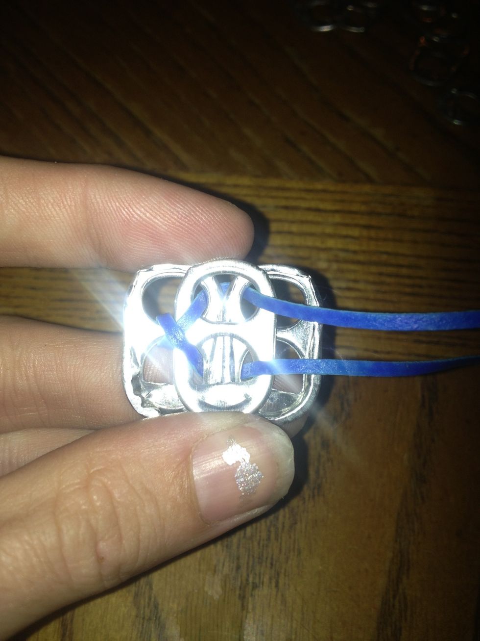 Take the top lace and put it through the top hole. Take the bottom lace and put it through the bottom hole.