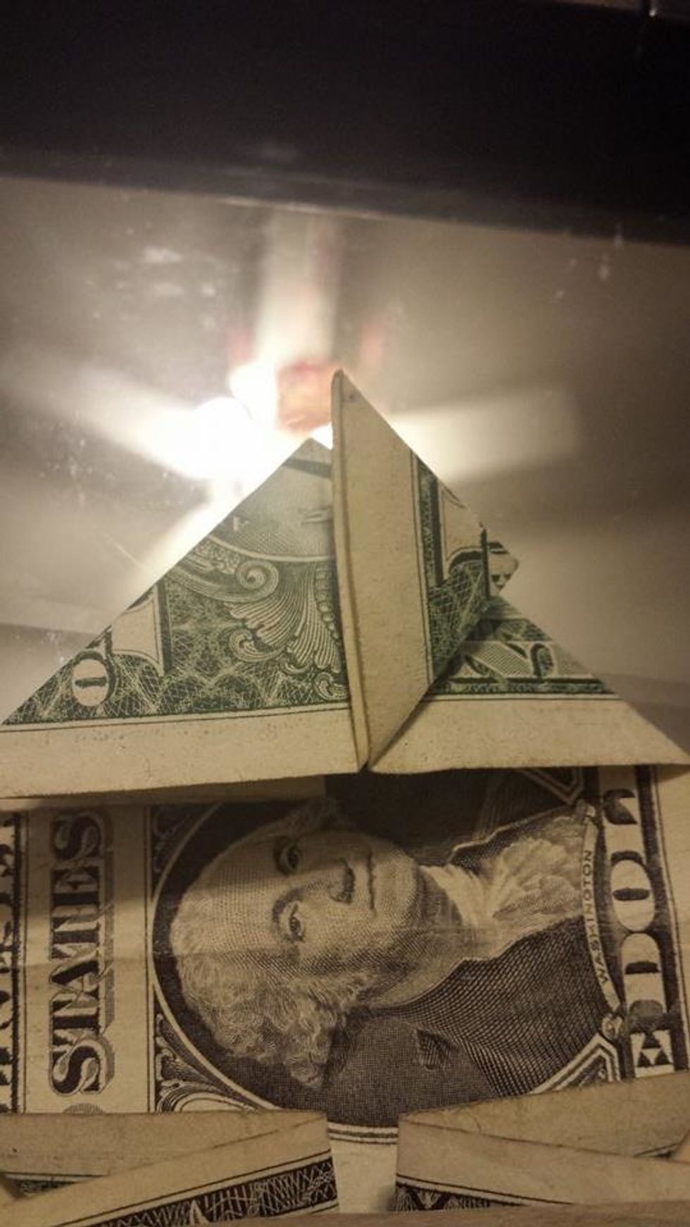 Take the top layer and fold it to the middle of the triangle.