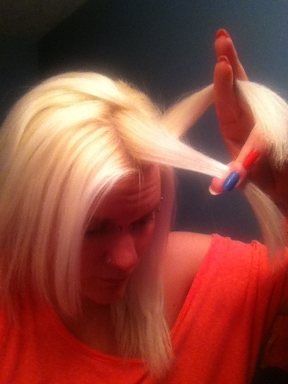 Take the top piece or the piece farthest from your face and bring it down, toward your face (base of the twist)