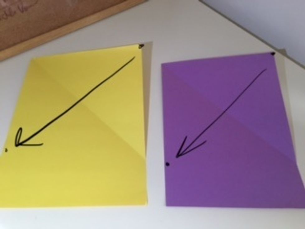 Take the top right corner and fold it down so the top side will line up with the left side. You can see the crease it will make. Do the same to the other paper.