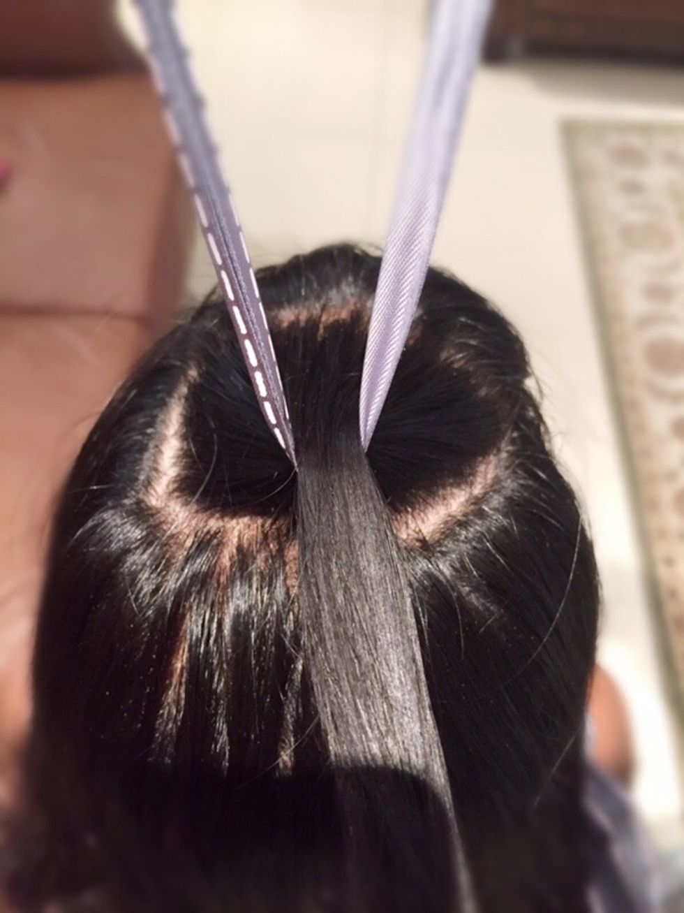 Take the top section of your hair and tie the ribbon around it.