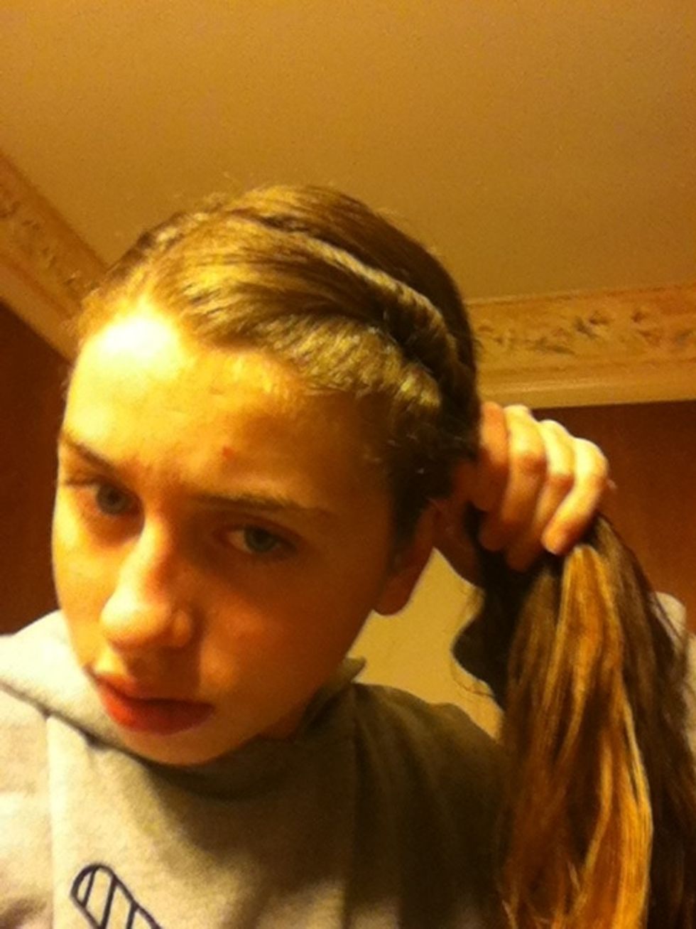 Take the twisted hair and add it with the rest of your hair to make a pony.