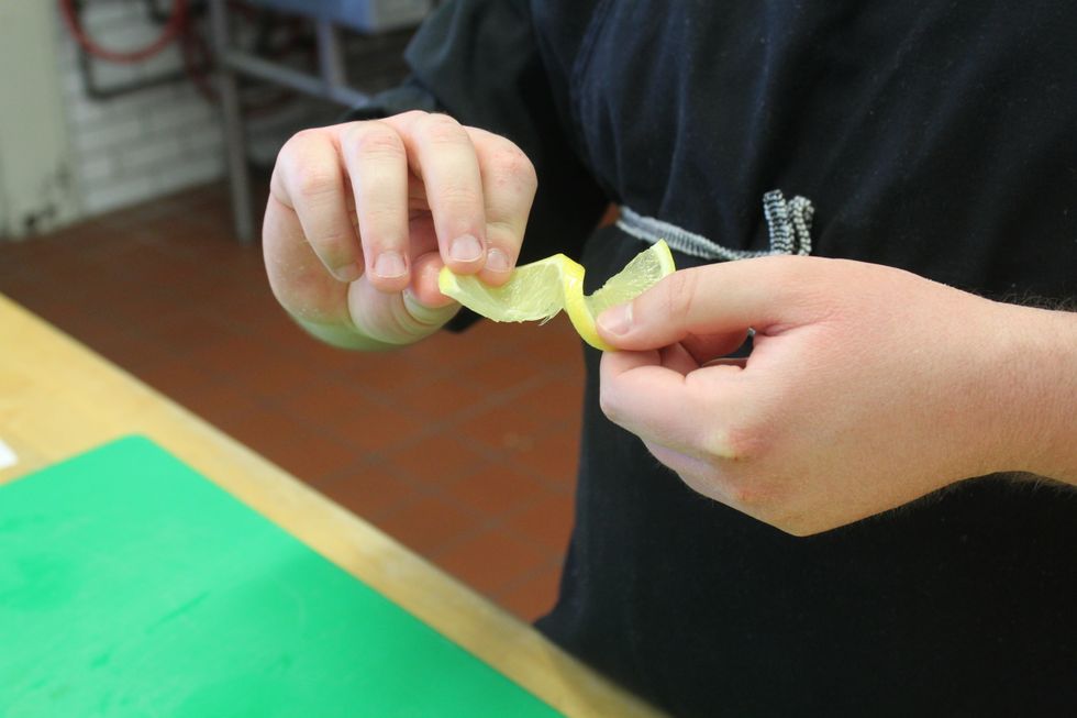 Take the two free sides of the lemon with your pointer fingers and thumbs.