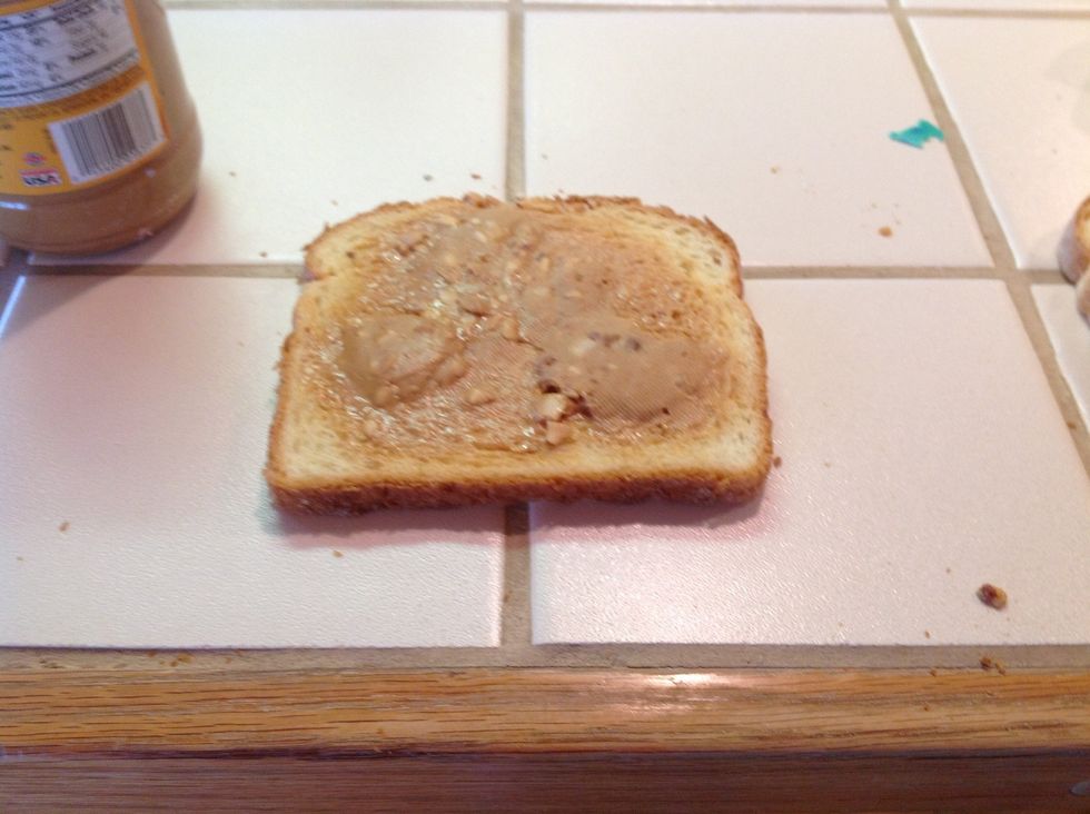 Take the two slices of bread (you can use any type of bread) and spread the peanut butter on one slice