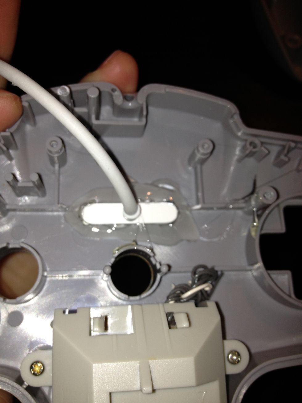 Take the USB and insert it into the newly-cut hole. Making sure the USB is facing the correct way, glue-gun it into place.