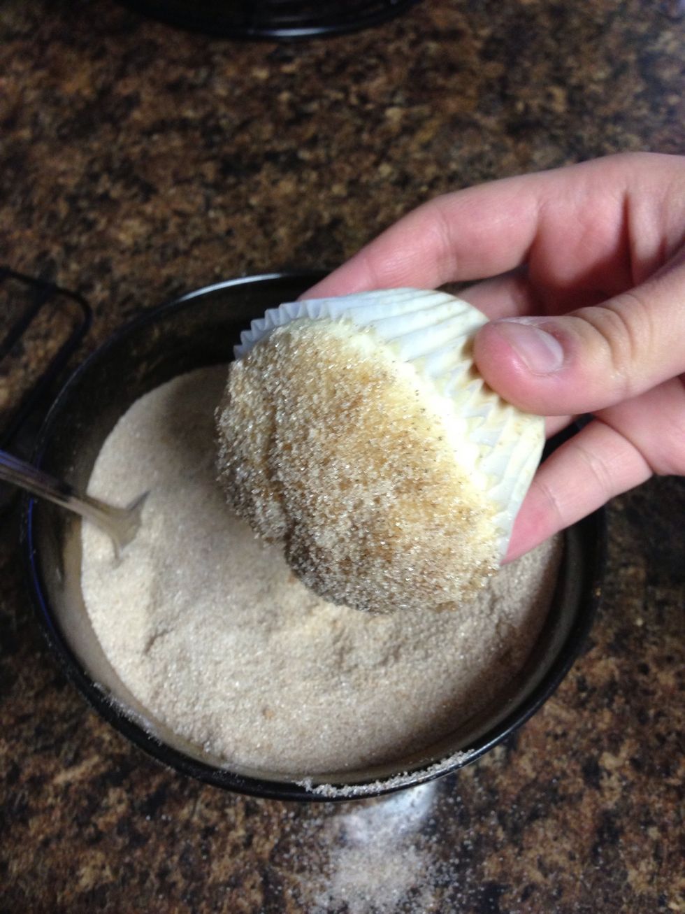 Take the warm muffin and thoroughly roll into the sugar and cinnamon mixture. If you're not coating the entire muffin, then coat  extra sugar on top. There will be leftover butter and sugar.