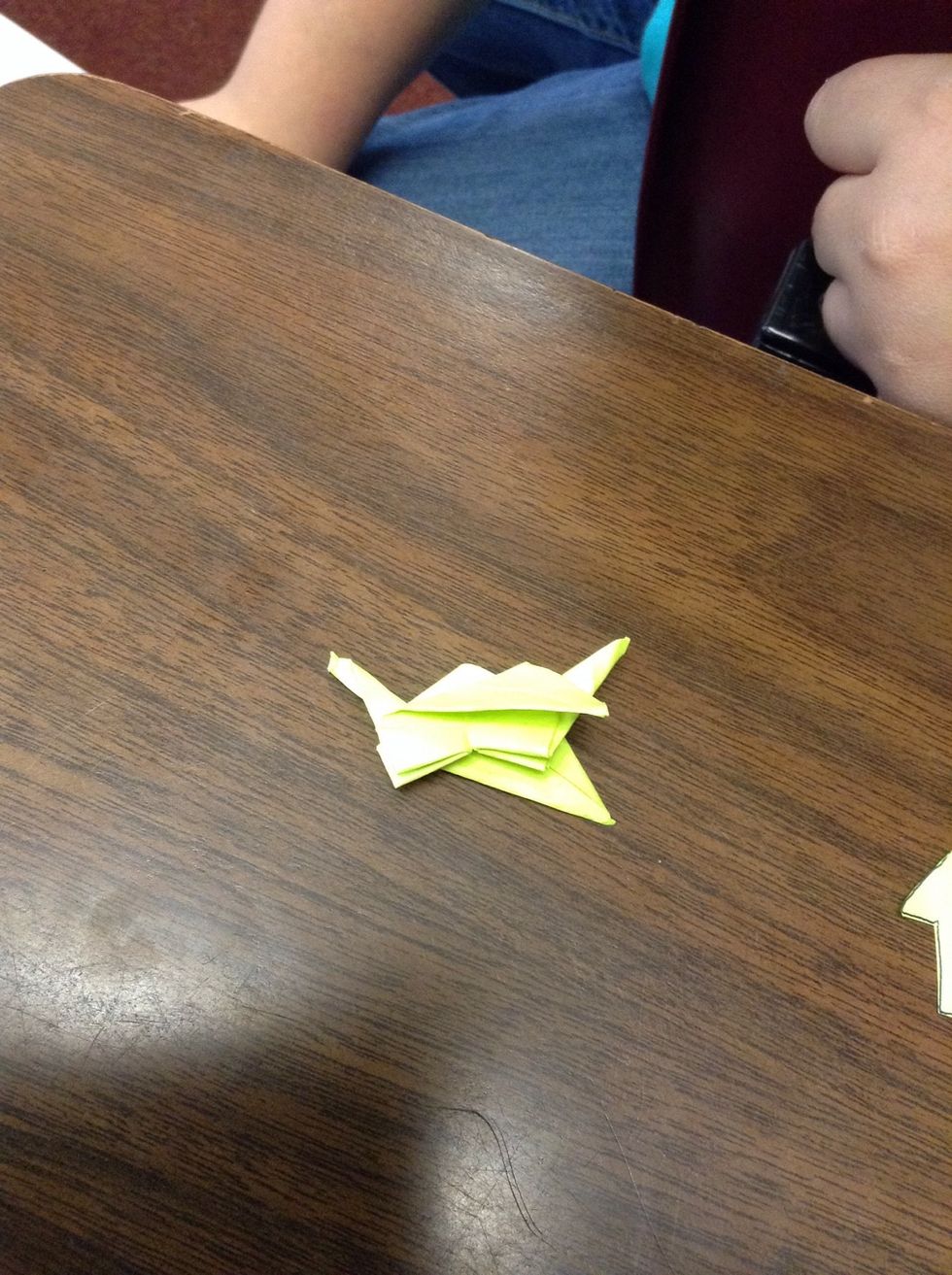 Take the wings and fold it at an angle so that the triangles point downward.
