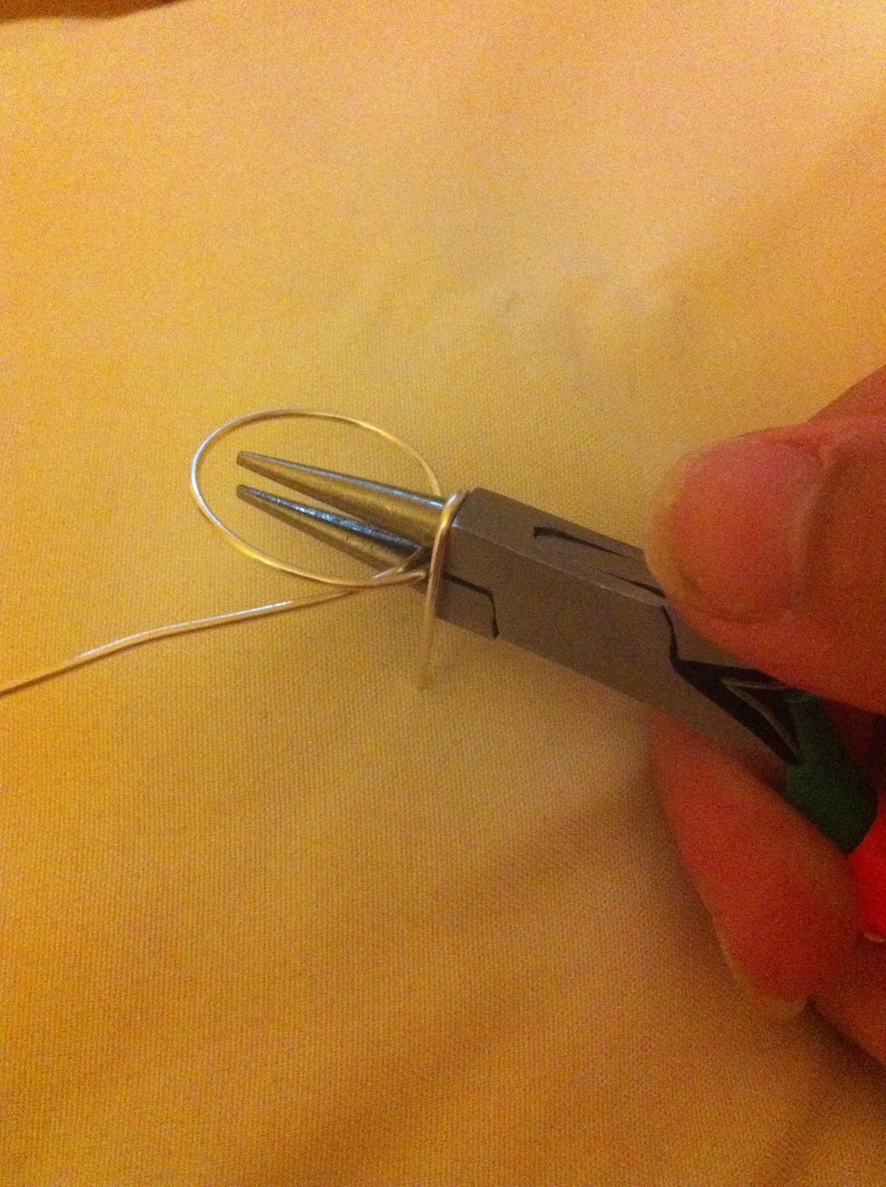 Take the wire and pull it around the widest part of the pliers.