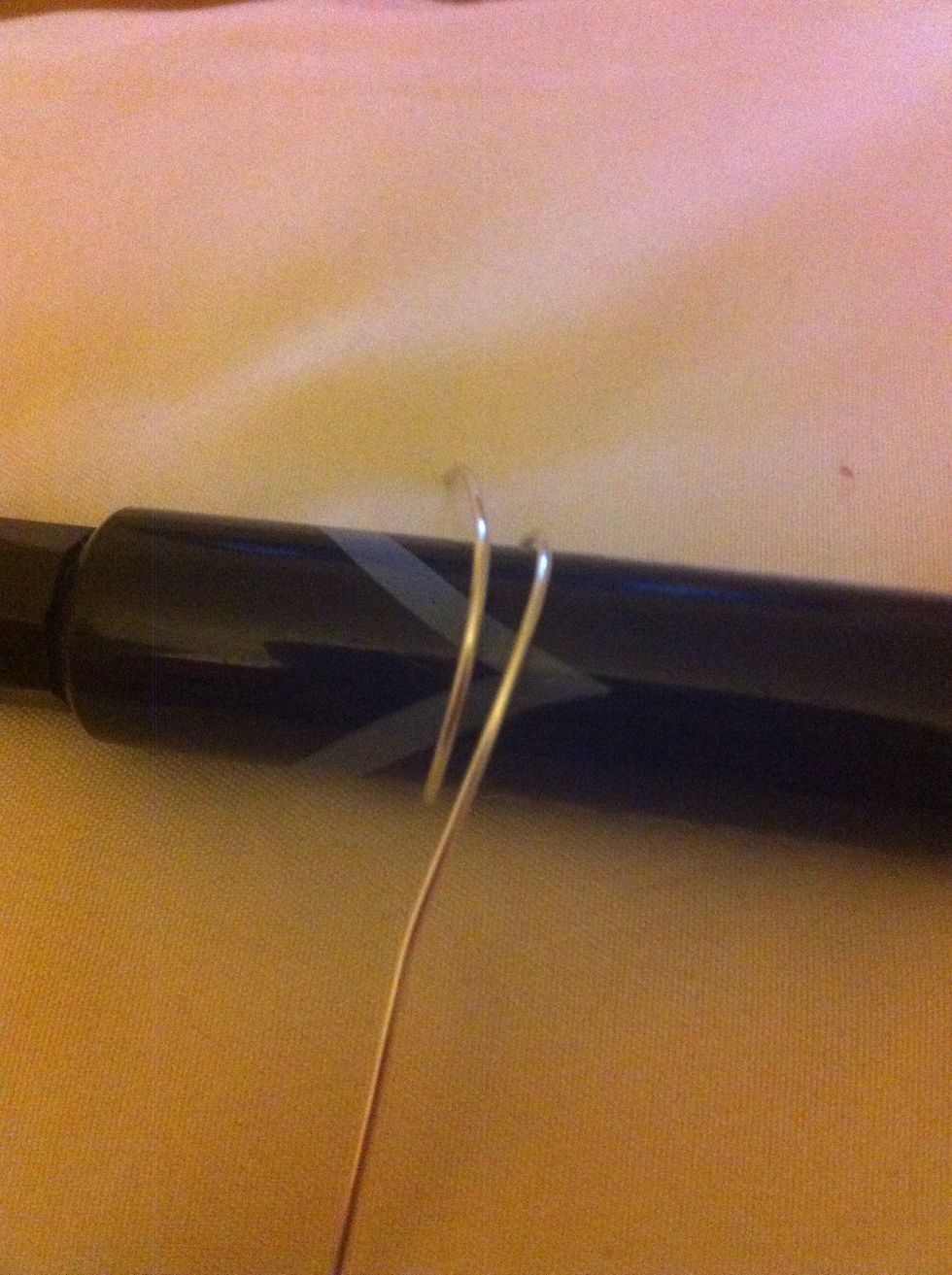 Take the wire and wrap it once a round the market or mandrel to get the shape of the ring.