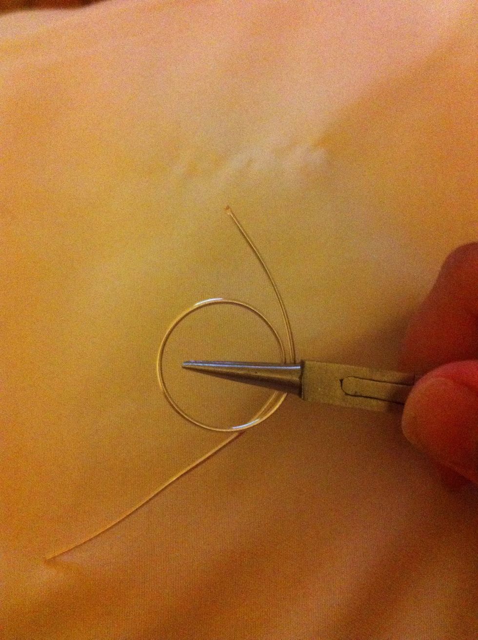 Take the wire off the base. Hold the wire in the pliers like so.