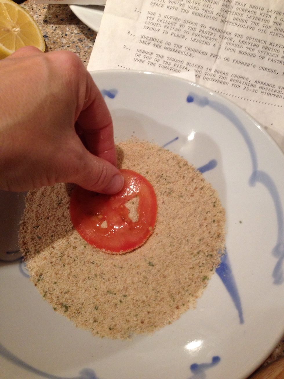 Take those thinly sliced tomatoes and coat them in the breadcrumbs.