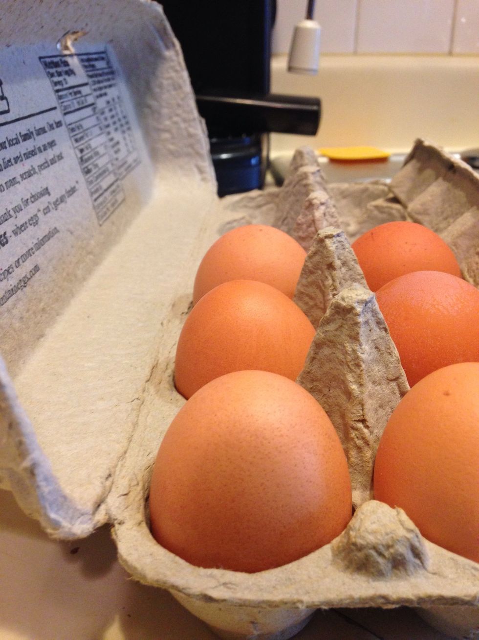 Take three eggs and whisk them in a bowl.