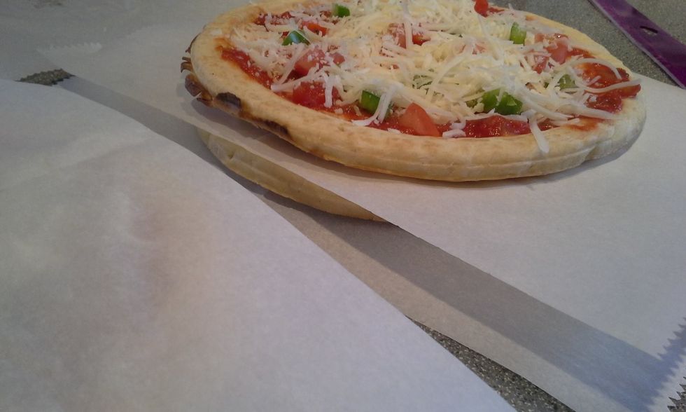 Take three pizzas and stack on top of each other with parchment paper between each pizza.