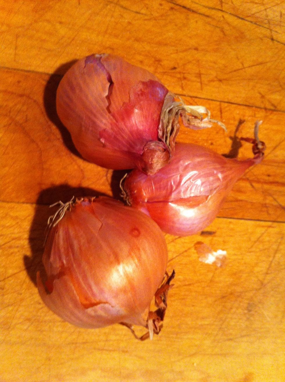 Take three shallots out and peel them.