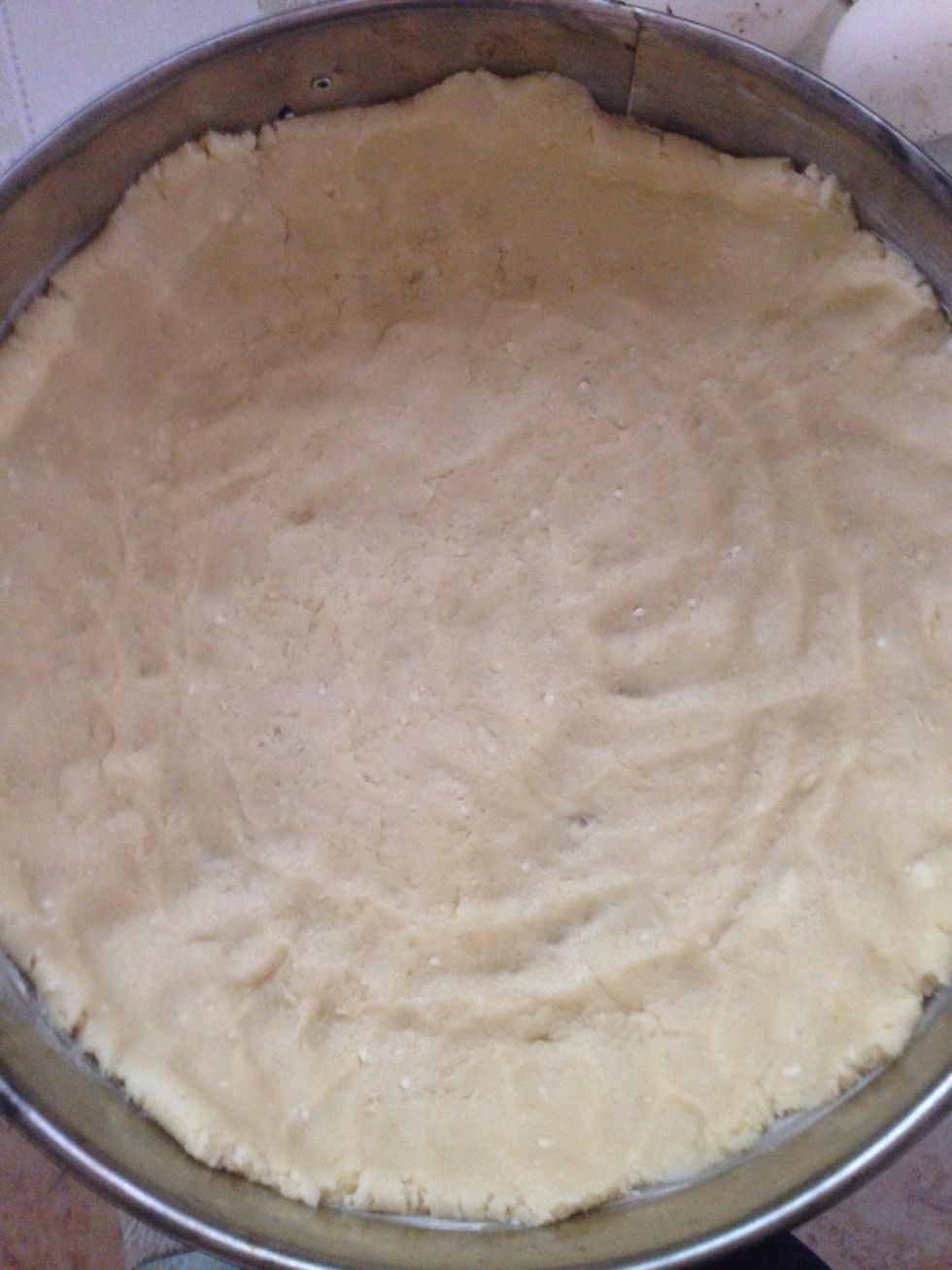 Take toe crust out of fridge and spread around the pan. Make sure to go go up the sides as well