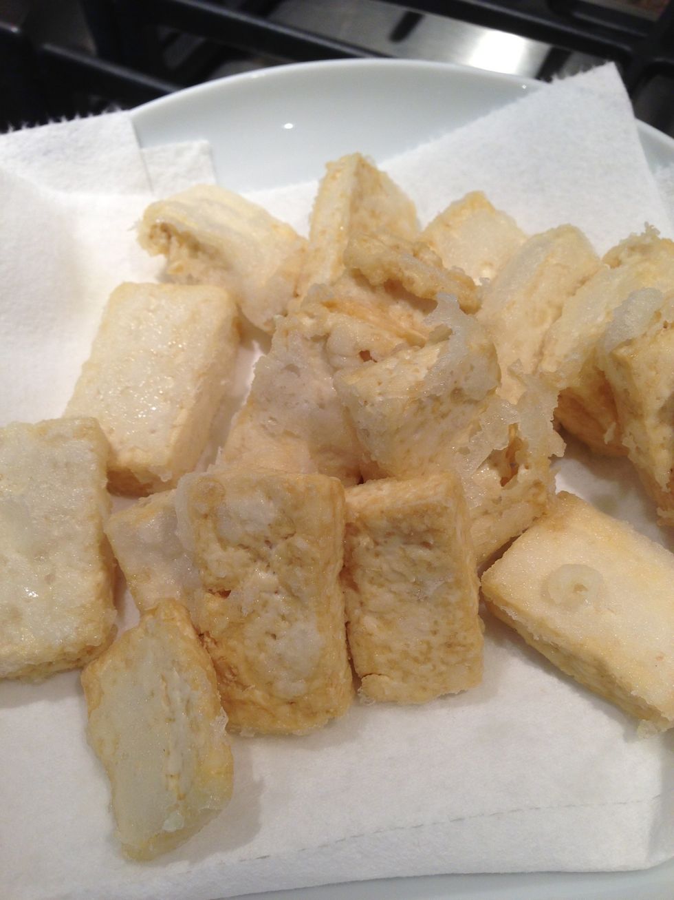 Take tofu out and put on a paper towel