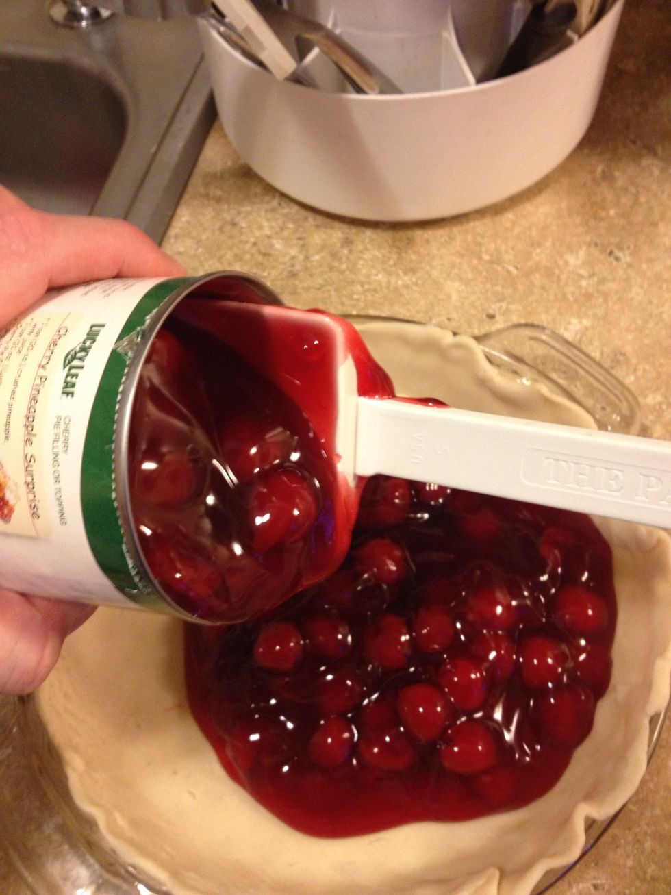 Take two cans of cherry pie filling and put on top crust