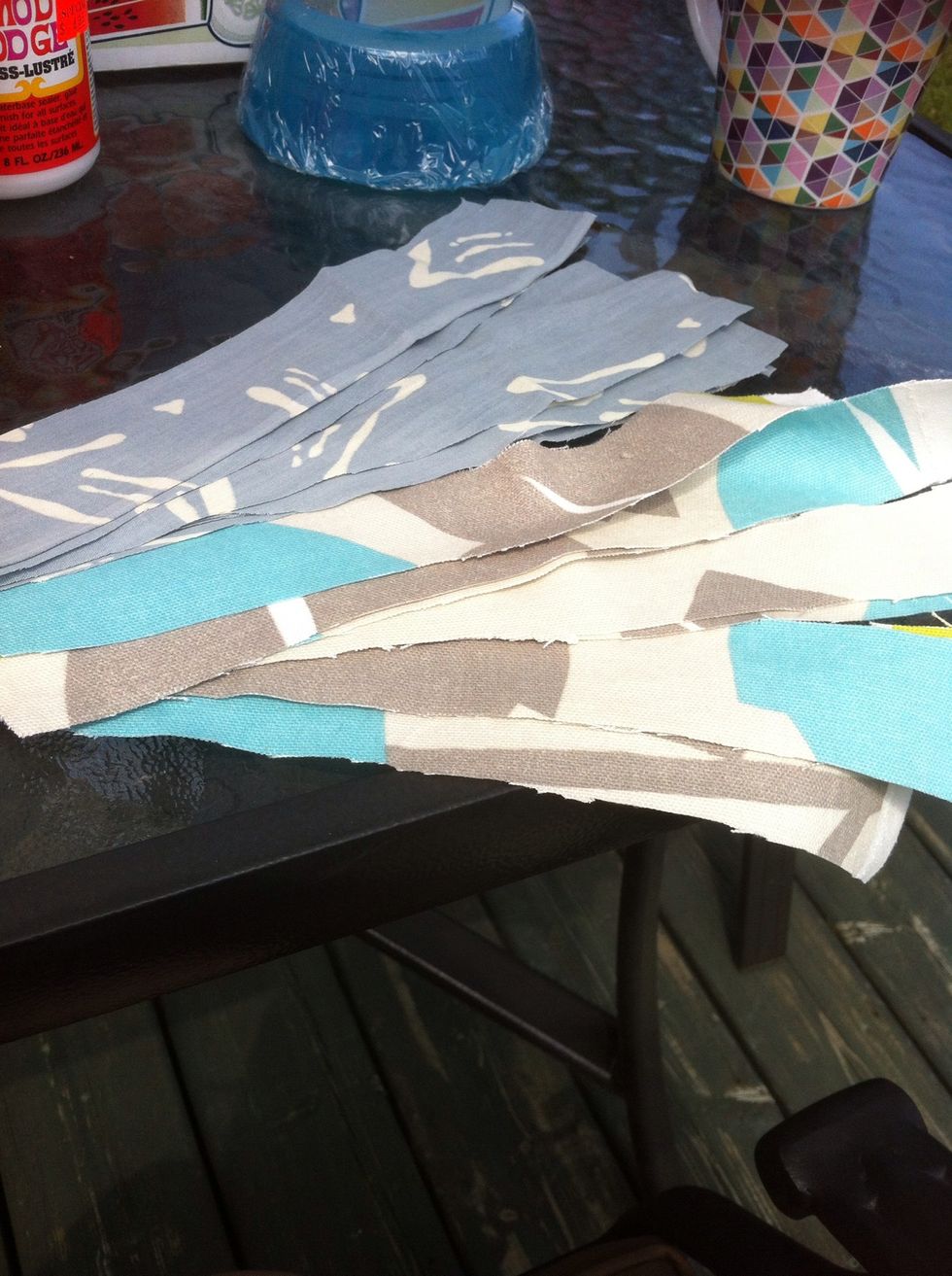 Take two fabrics you like, cut strips of about 1" each, long enough so that it falls on each sode of the bowl you want to cover. Then let sit in the modpodge mixture for a minute or two