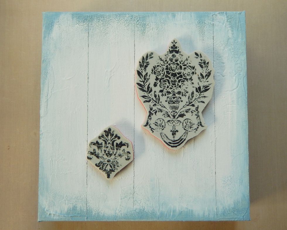 Take two of the Distress Damask stamps and use them as guides for drawing parallel lines onto the dry gesso.