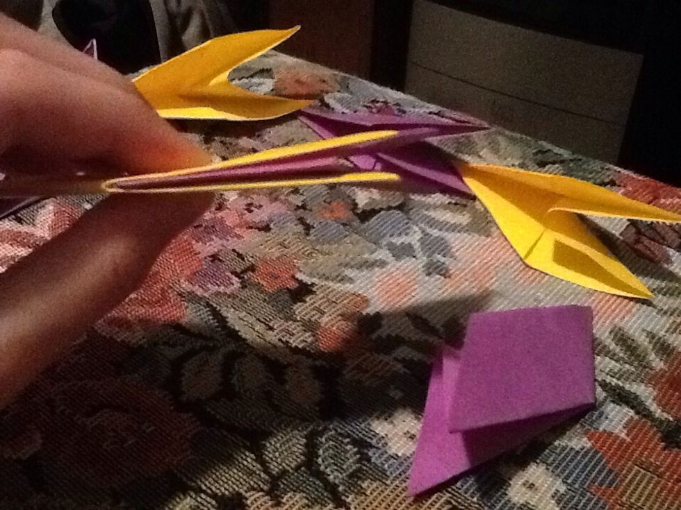 Take two of them and let's say yellow is 1 and purple is 2. Put the 2 all the way between the 1st one. Put them together like when you just made them.