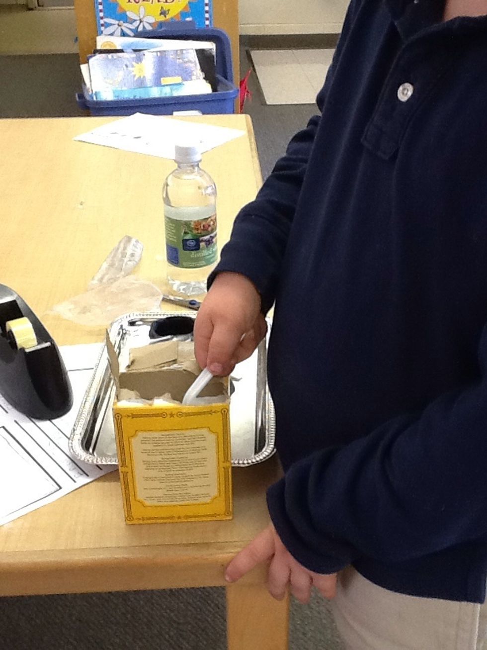 Take two spoonfuls of baking soda and put it in the volcano. You may need three or four spoonfuls.