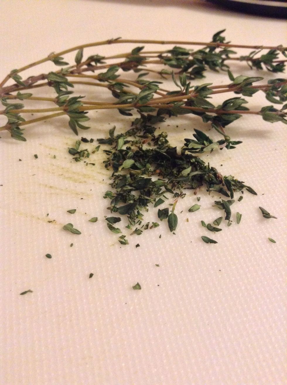 Take two sprigs of thyme and take the leafs off. You won't want to use the stem of the thyme because it's kind of woody. Chop the leafs as fine as possible and set aside.