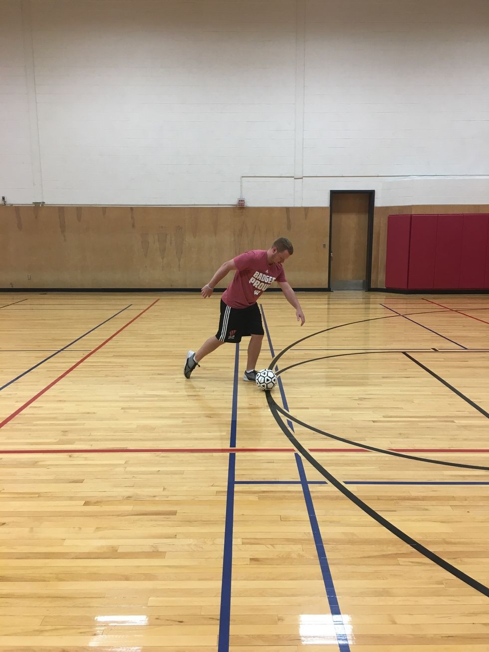 Take two steps towards the ball and plant your non kicking foot next to the ball. Keep your eye on the ball