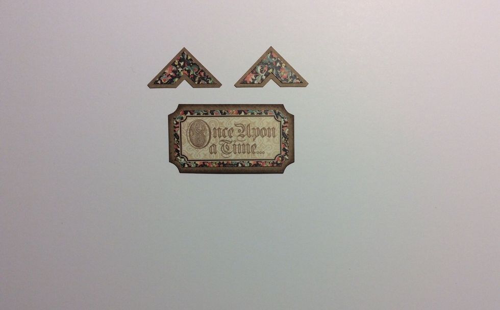 Take two sticker corners and a ticket sticker as shown from the graphic 45 enchanted forest sicker sheet and adhere to Kraft cardstock. Trim a border around each piece.