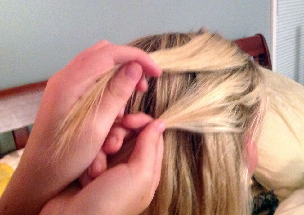 Take two strands of hair near the top of the head, but not too big.