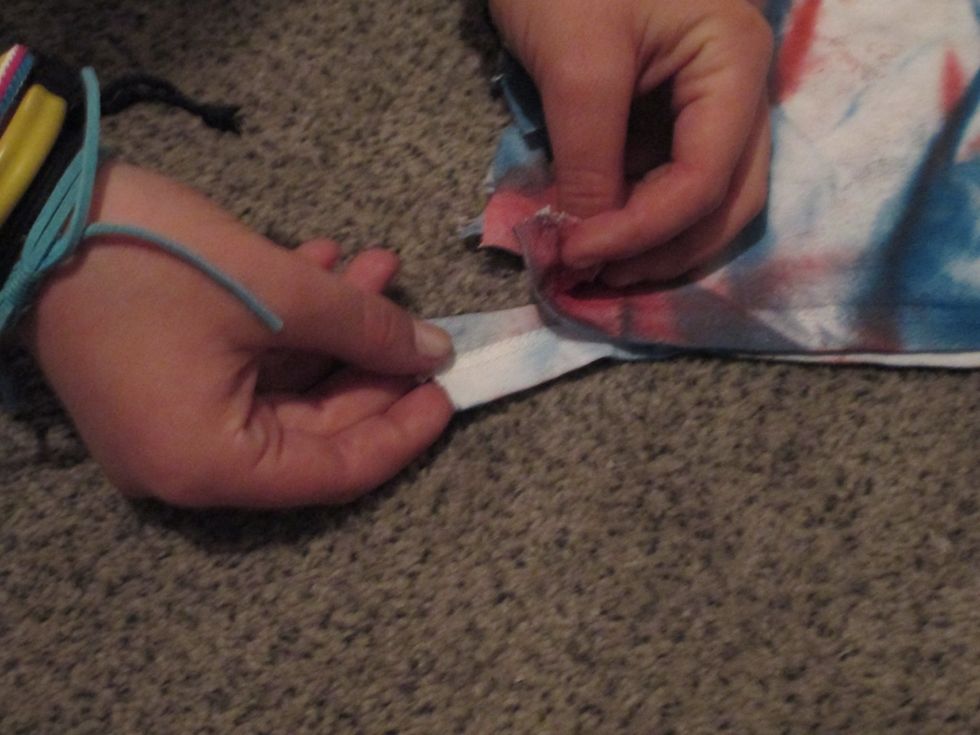 Take two tabs, one from each side, and double knot them.