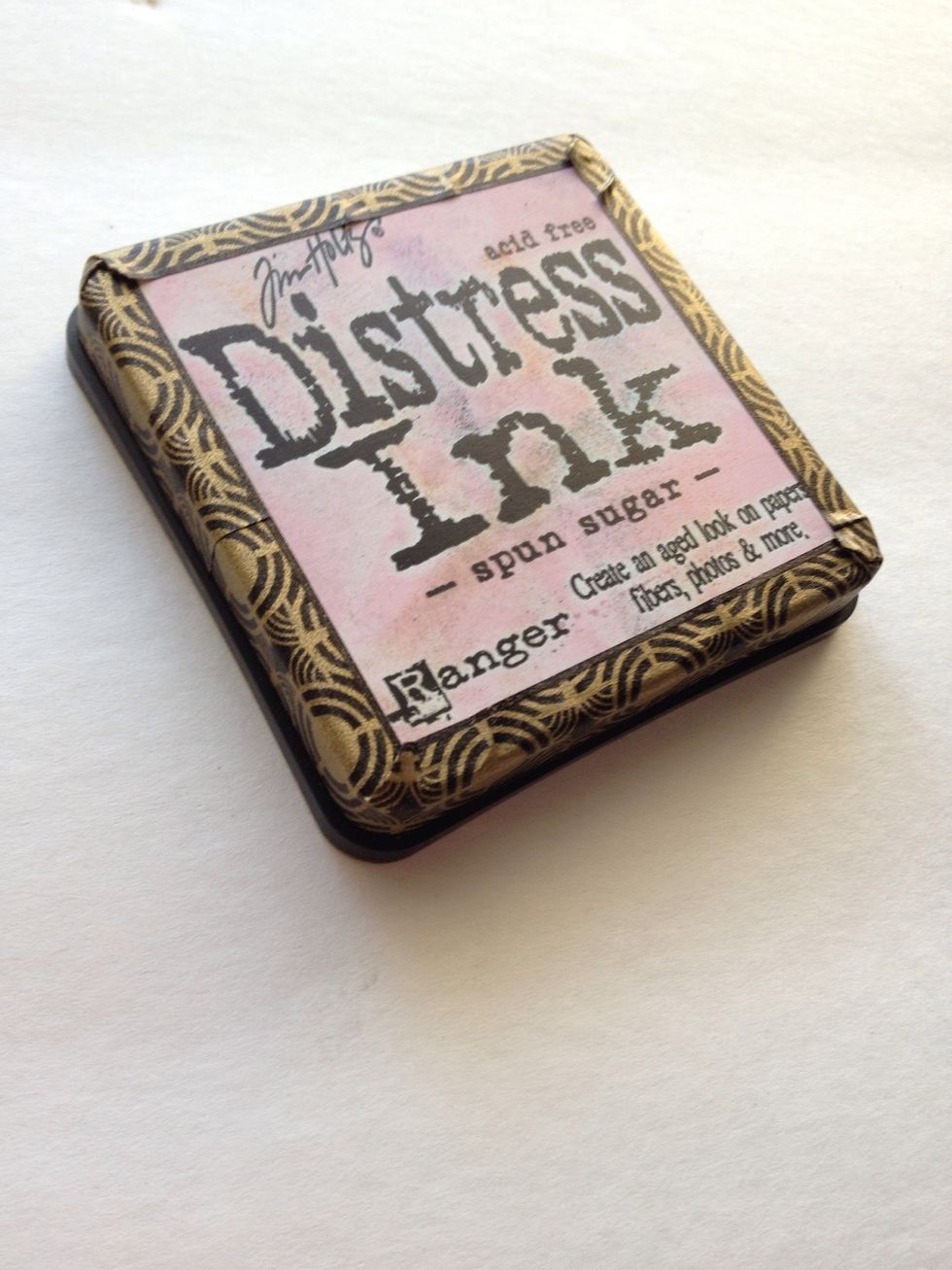 Take washi and wrap around the lid of your ink pad as shown. Again, apply some adhesive behind washi before attaching for extra hold.